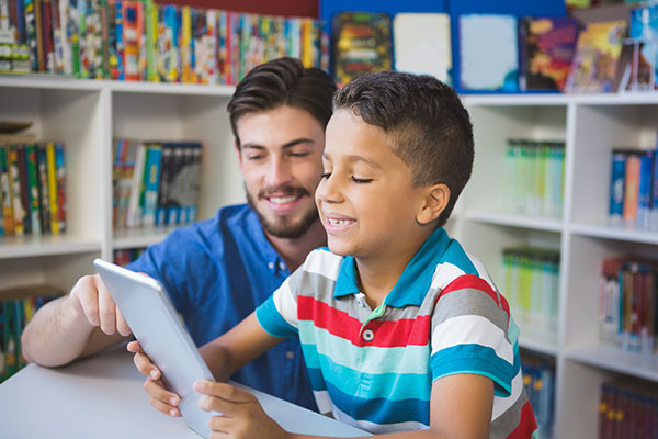 Boy and teacher conferring